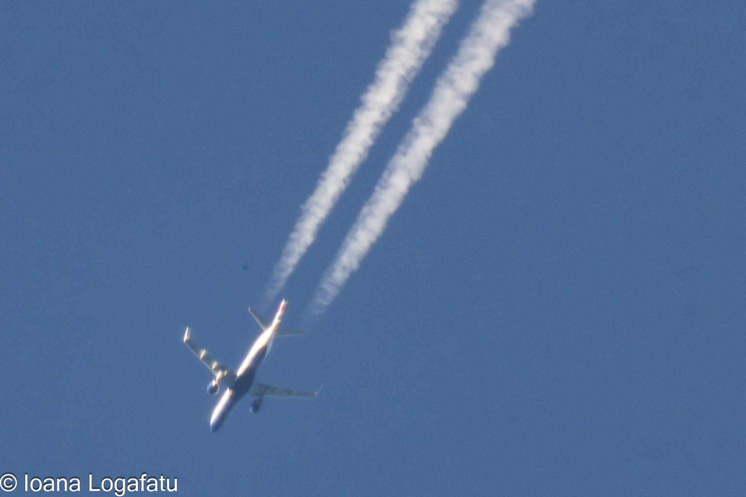 Jet flying high in clear blue sky